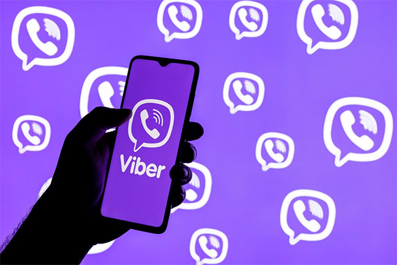 Mobiltelefon-képernyő Viber-hívás-ikonnal, a kék háttérben a Viber-hívás ikonja sokszorozva, különböző méretben